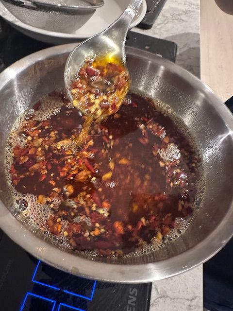 Chili oil being prepared in a pan